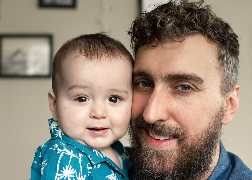 a baby and dad smiling during a chicago in-home family photography session