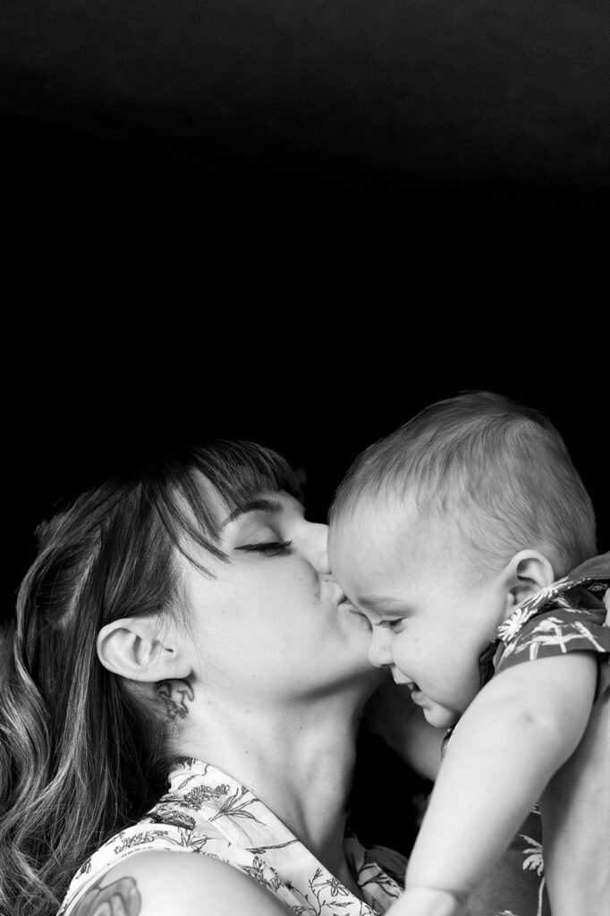 a mom kissing her son's forehead during a Chicago family photoshoot