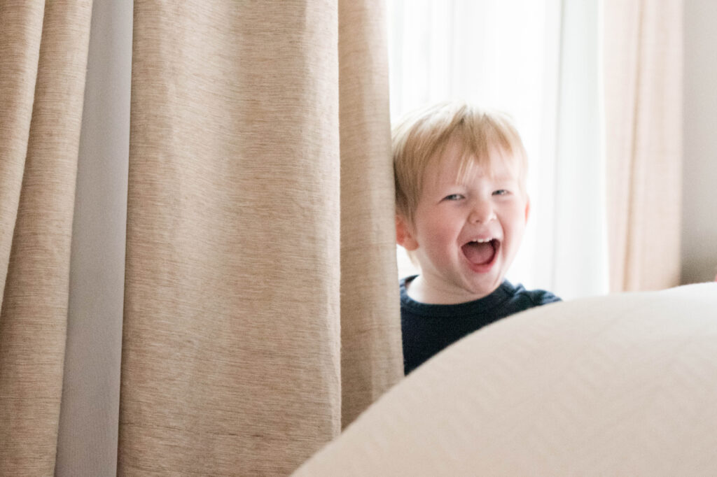 a boy laughing during a chicago in-home family photography session