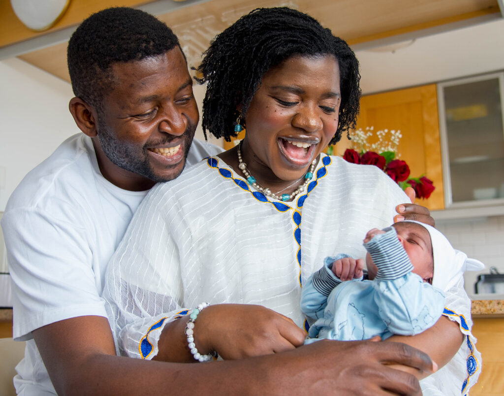 parents looking at their newborn during a chicago in-home family photography session