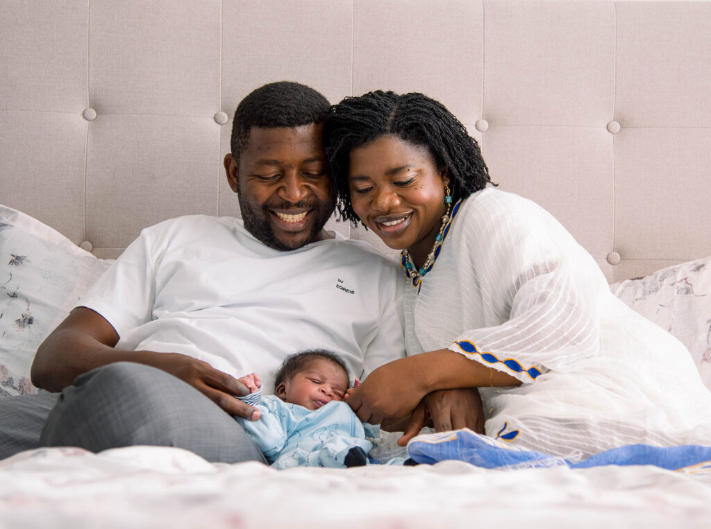 new parents smiling during a chicago in-home family photography session